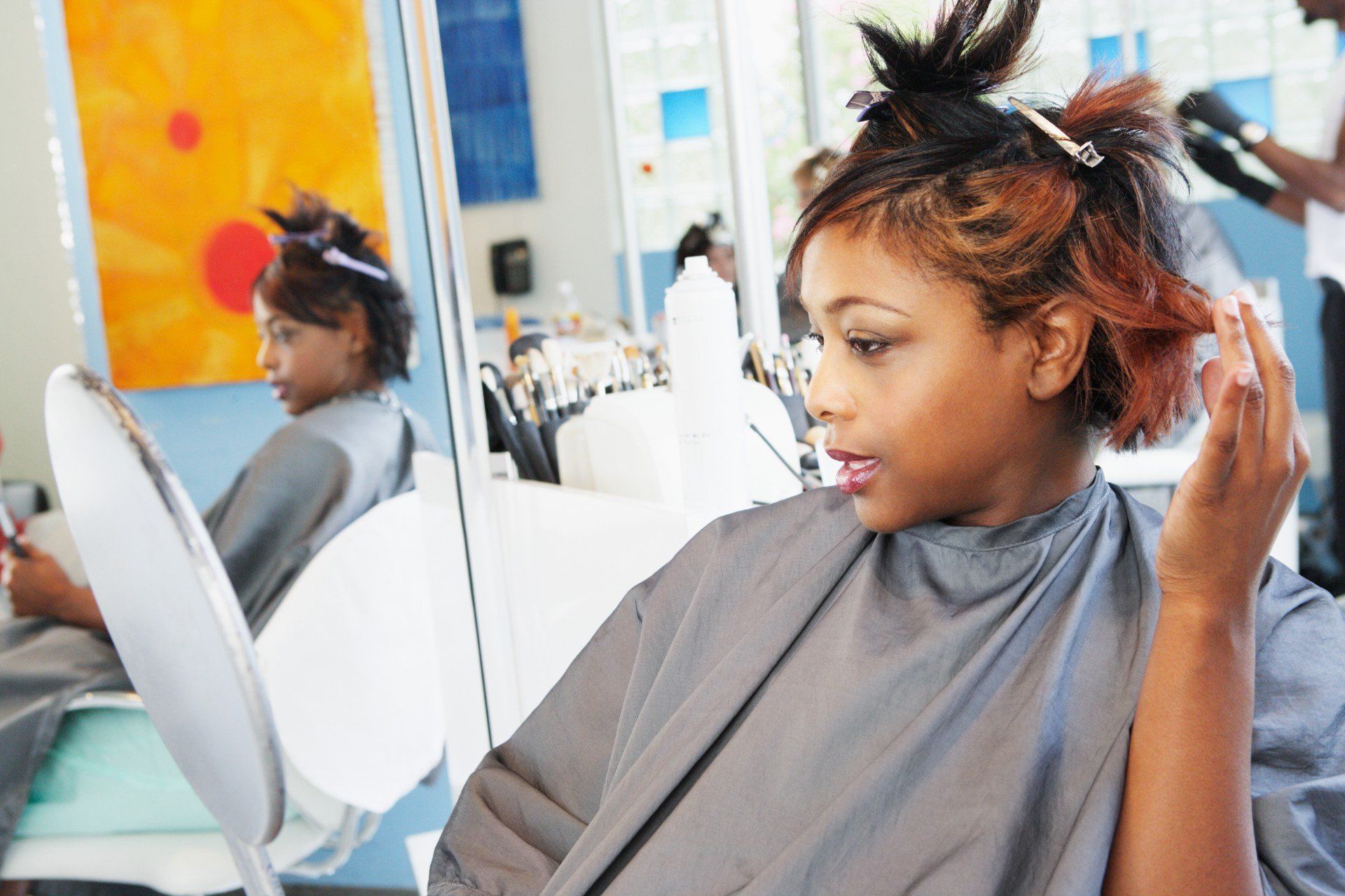 Young woman examining herself in the mirror at salon