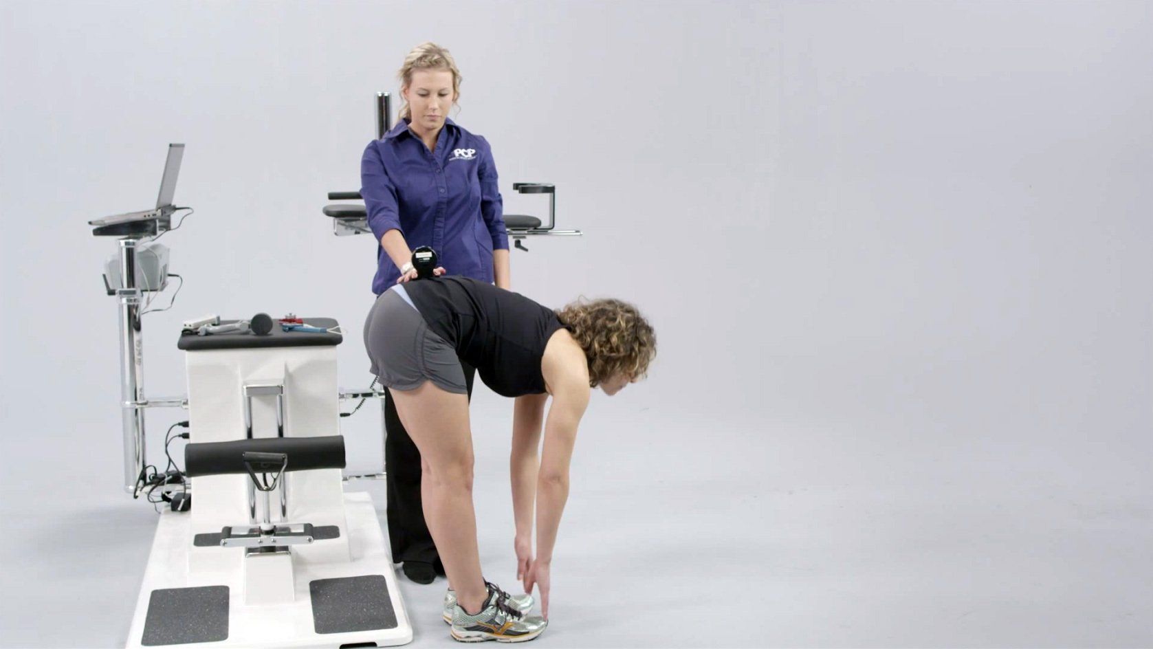 Woman bending over during physical employee test