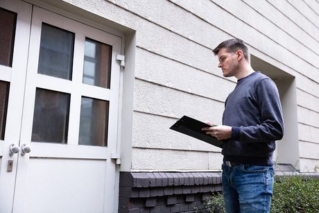 male holding a check list