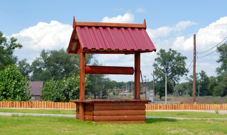 a water well with red roof