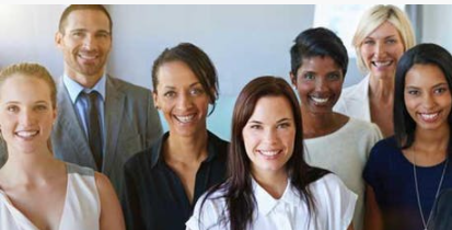 A group of people are posing for a picture together and smiling.