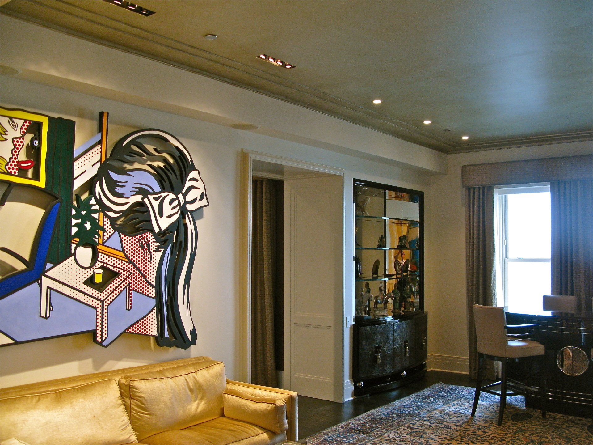 A living room with a couch and a painting on the wall