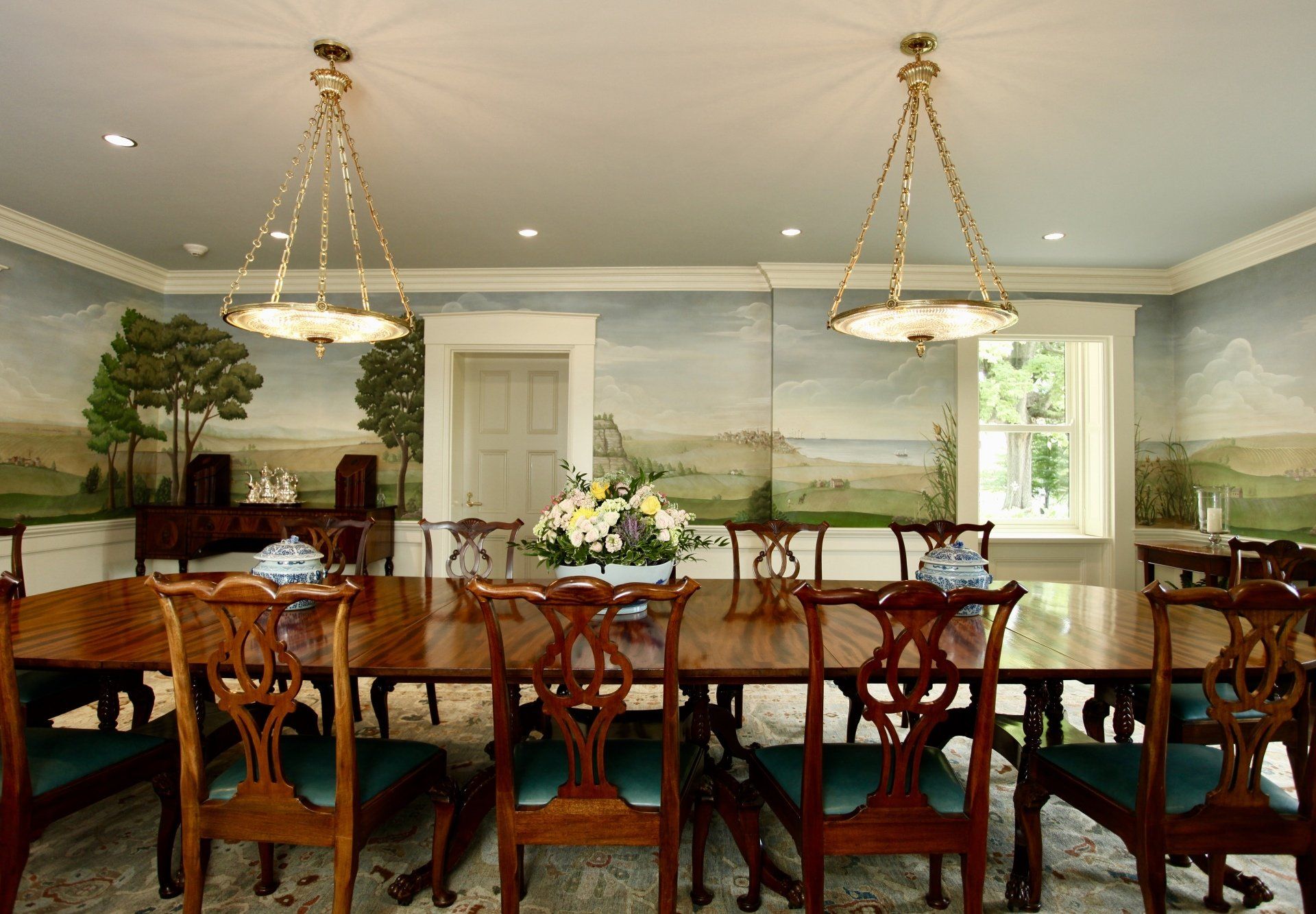 A dining room with a long table and chairs