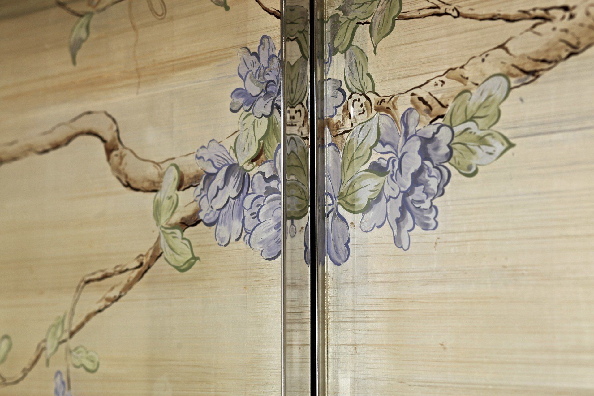 A close up of a door with a painting of flowers on it