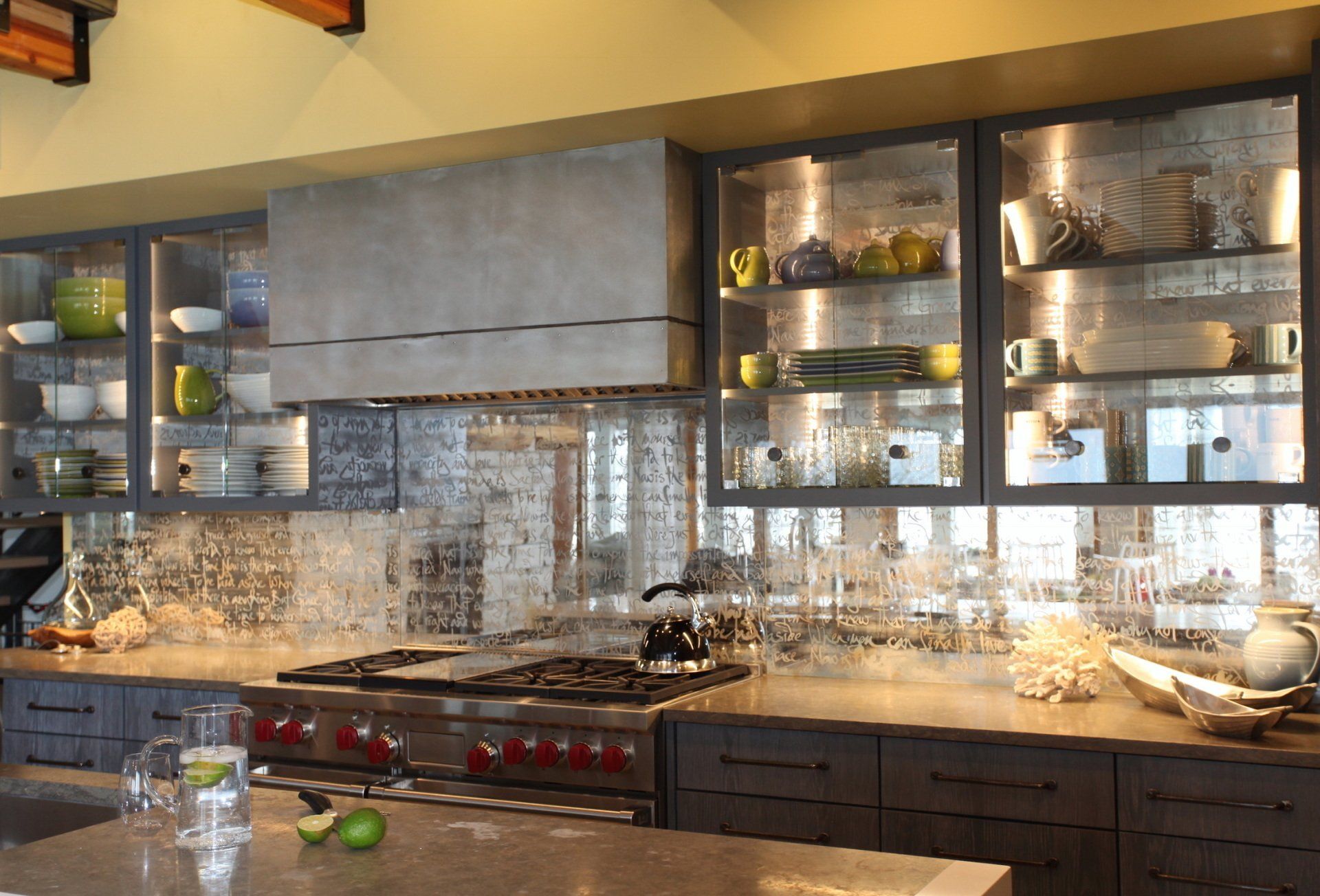 A kitchen with stainless steel appliances and glass cabinets