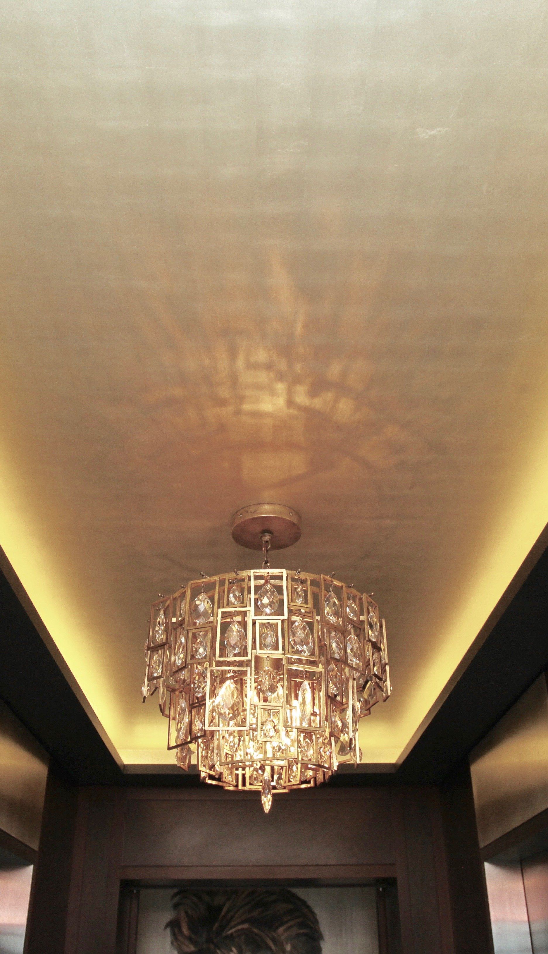A large chandelier is hanging from the ceiling of a room.