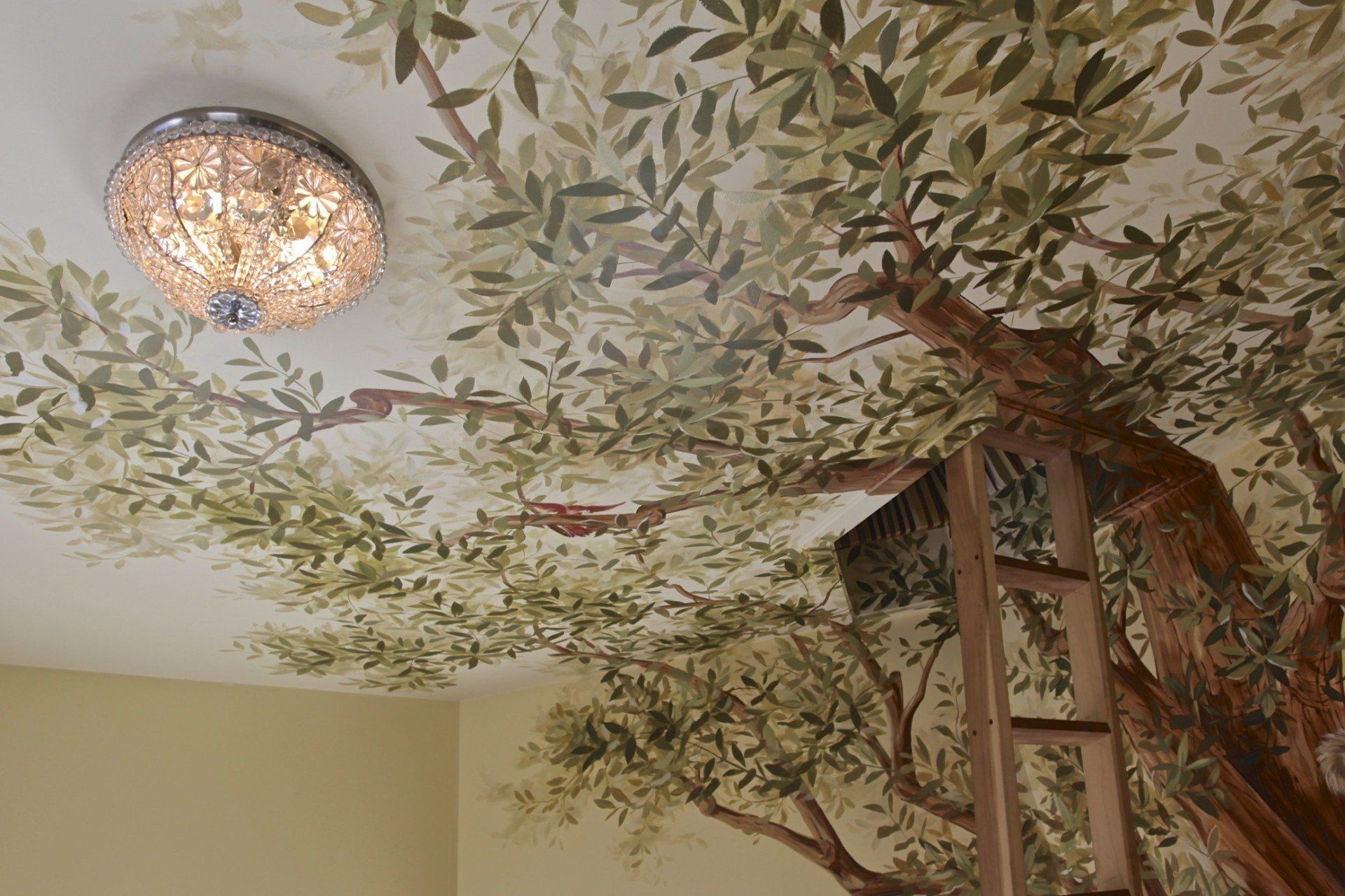 A ceiling with a painting of a tree on it