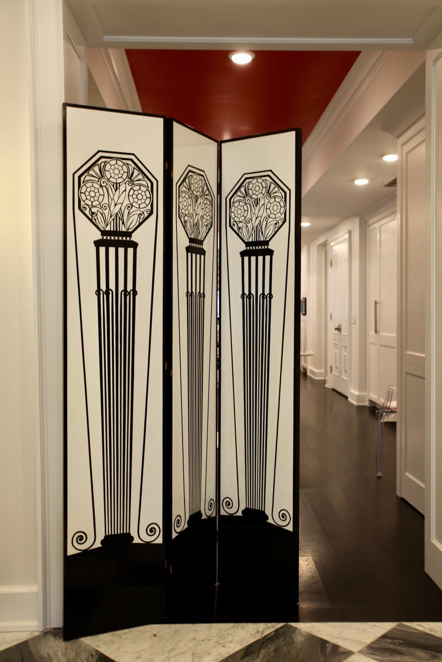 A black and white room divider in a hallway