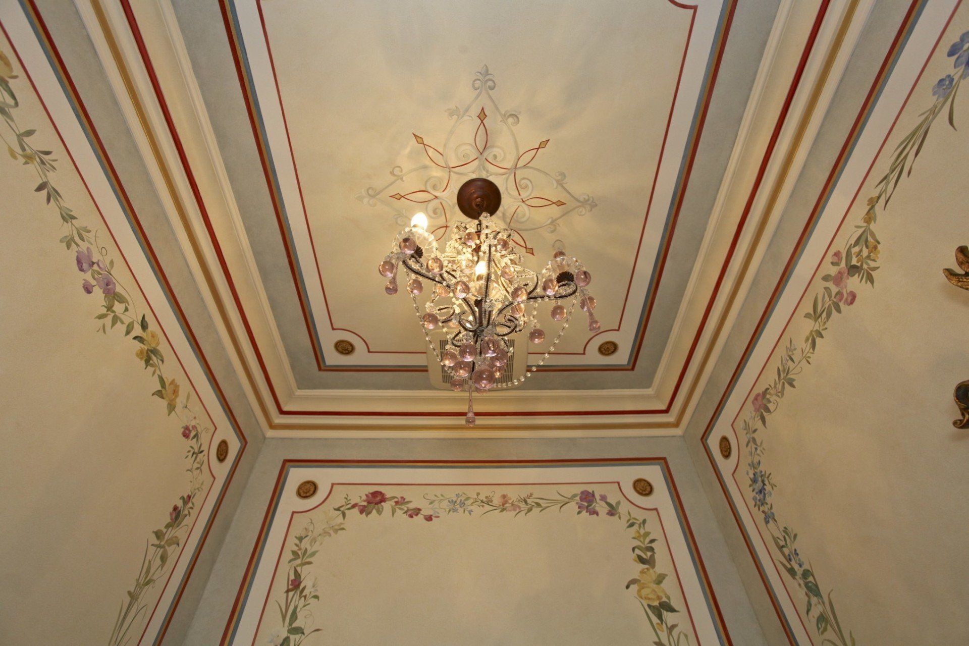 A chandelier is hanging from the ceiling of a room