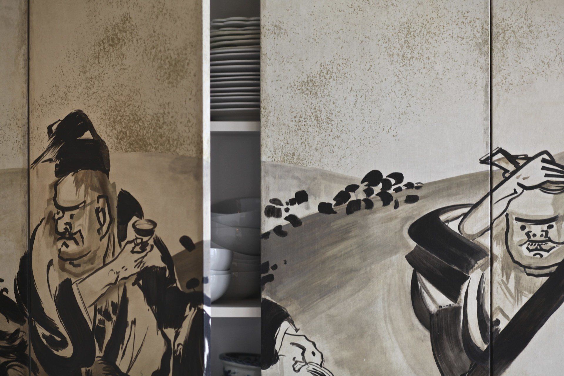 A black and white painting of a man sitting at a table
