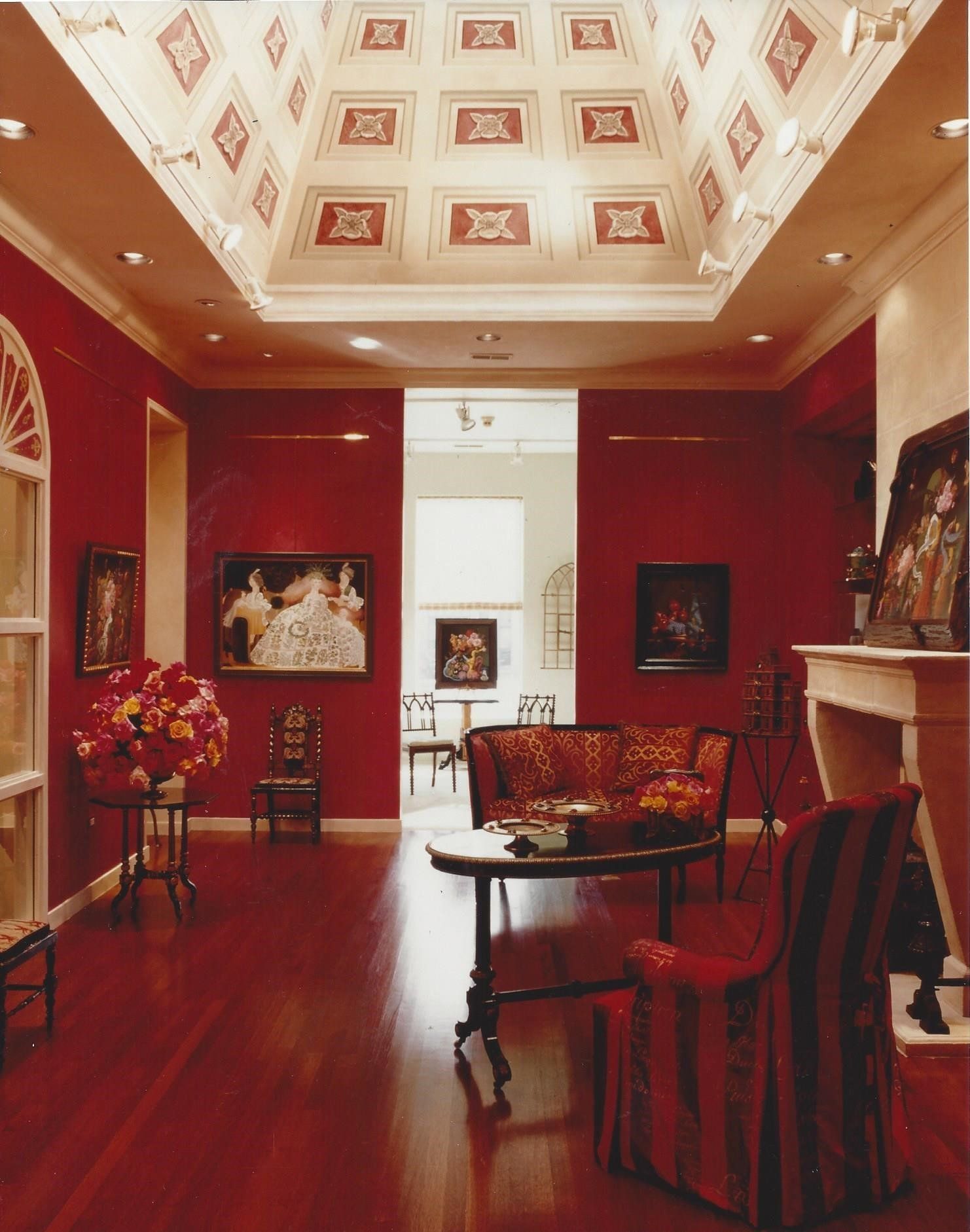 A living room with red walls and a white ceiling