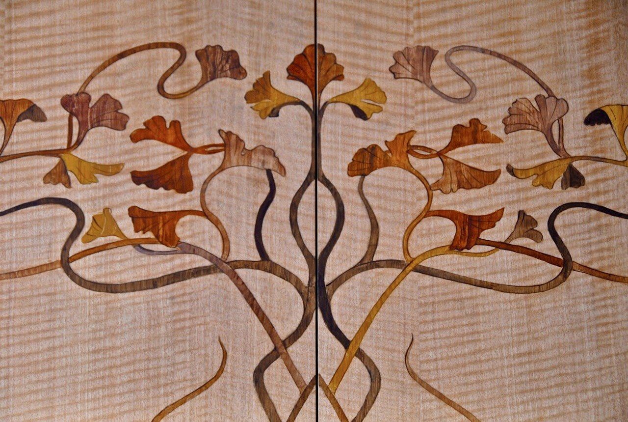 A piece of wood with a tree design on it
