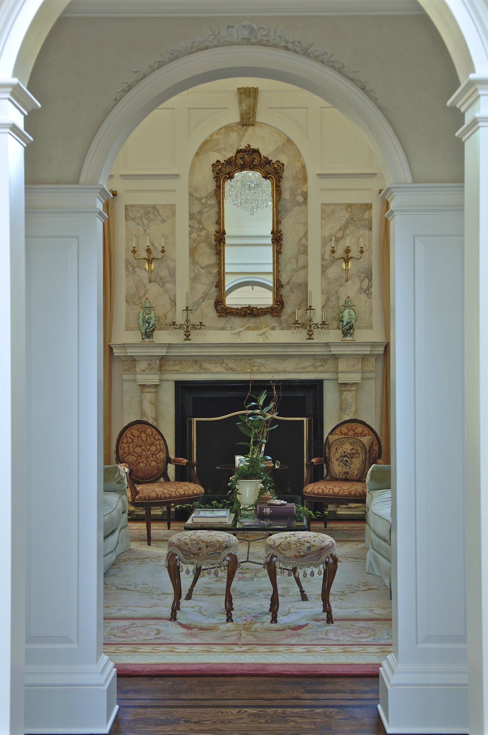 A living room with a fireplace and a mirror on the wall