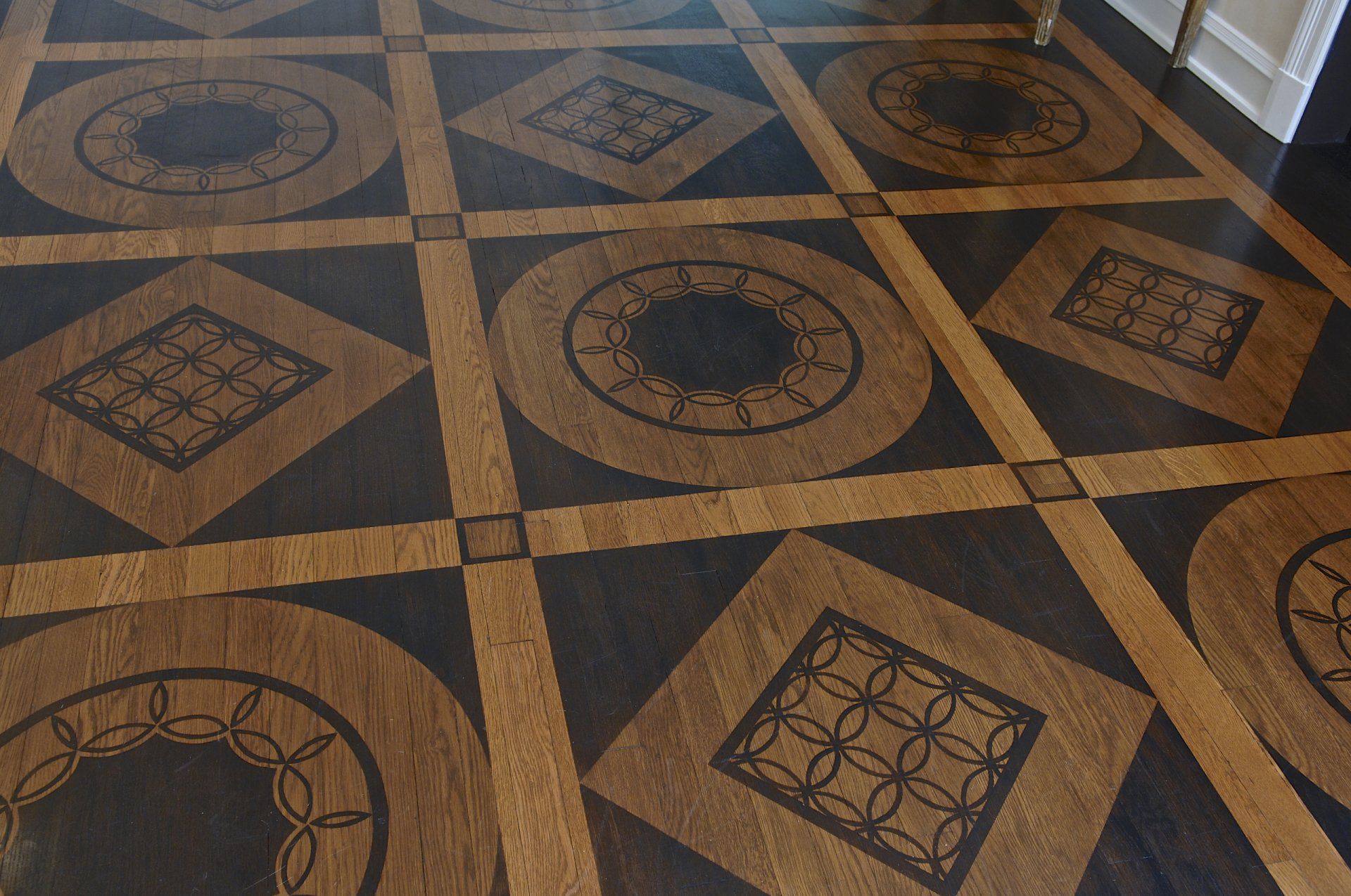 A wooden floor with circles and squares on it