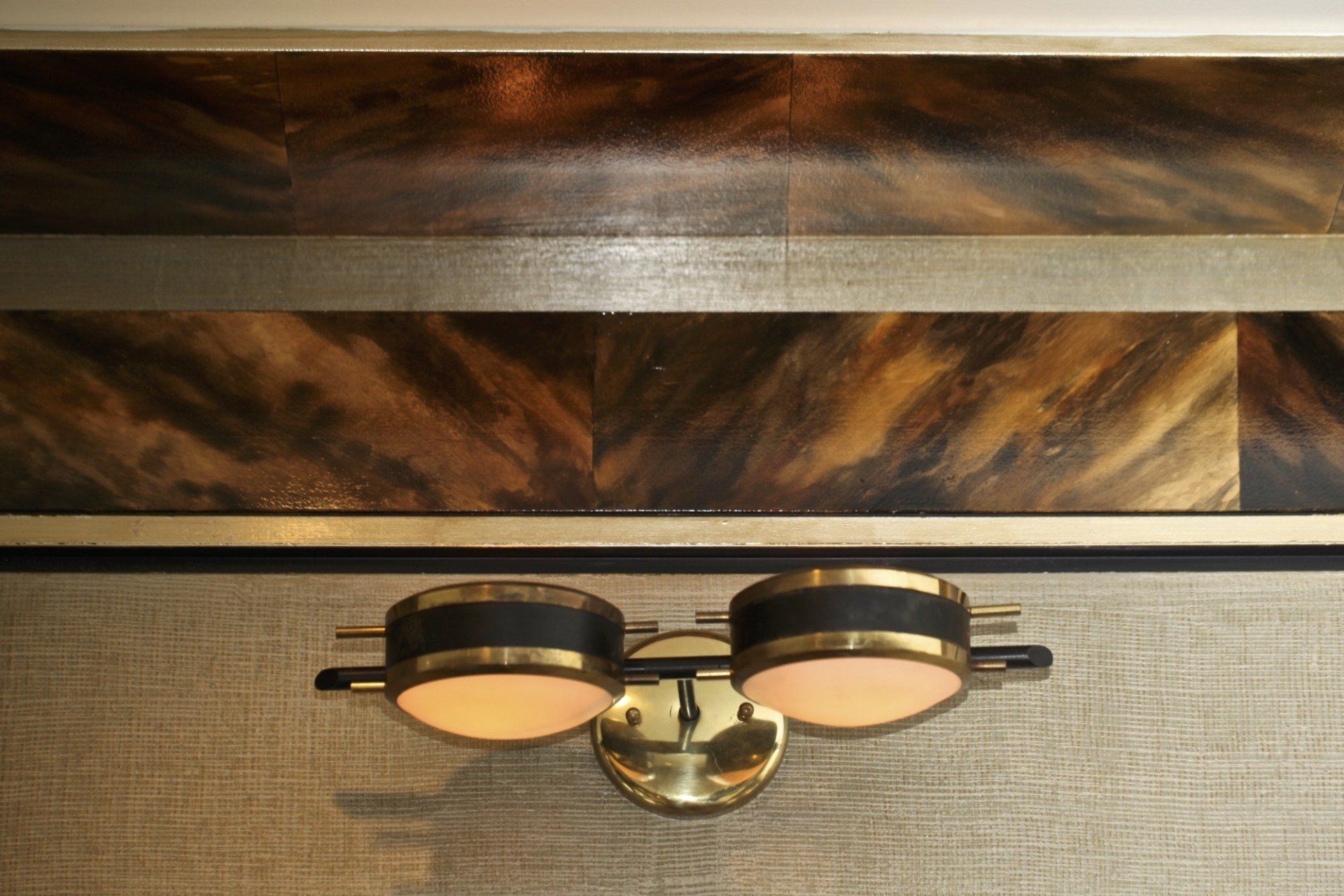 A close up of a light fixture on a wall.