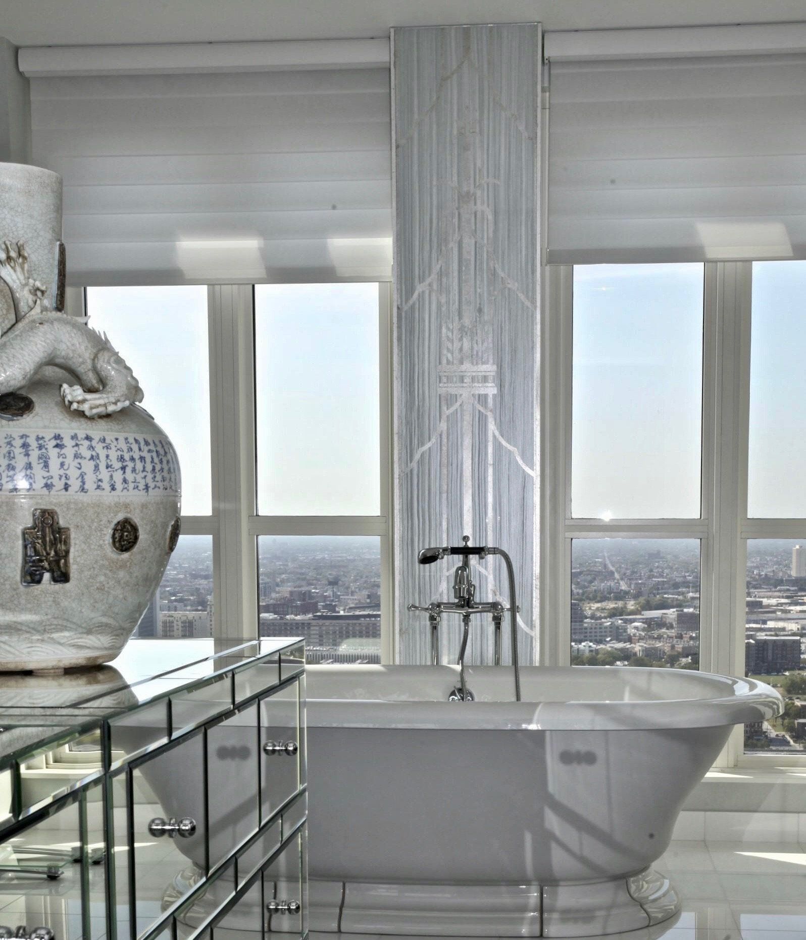 A bathroom with a tub and a vase in the background
