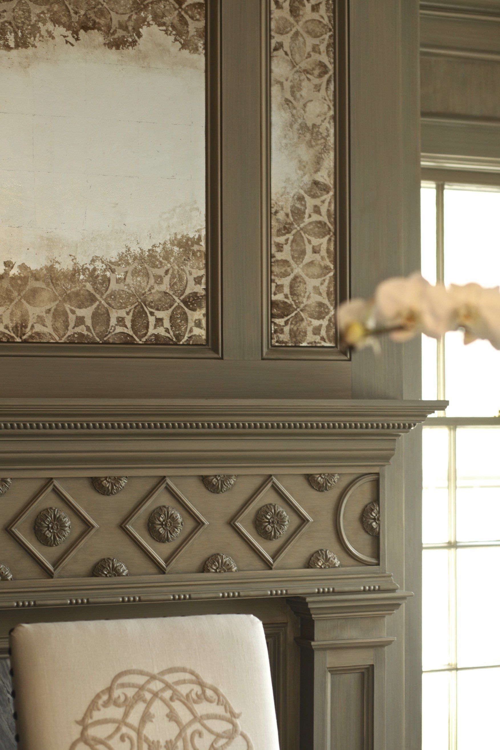 A chair is sitting in front of a fireplace in a living room