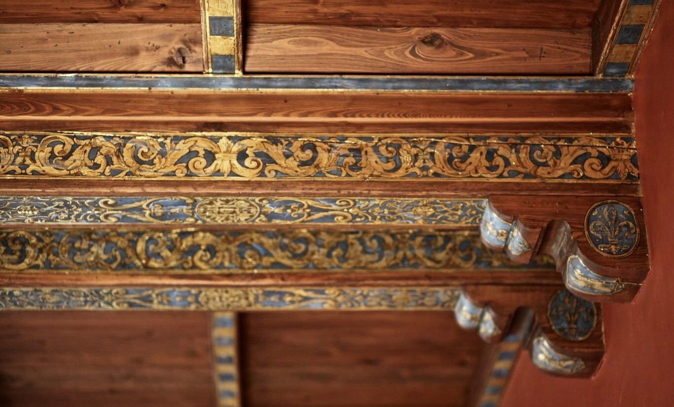 A close up of a wooden ceiling with a pattern on it.