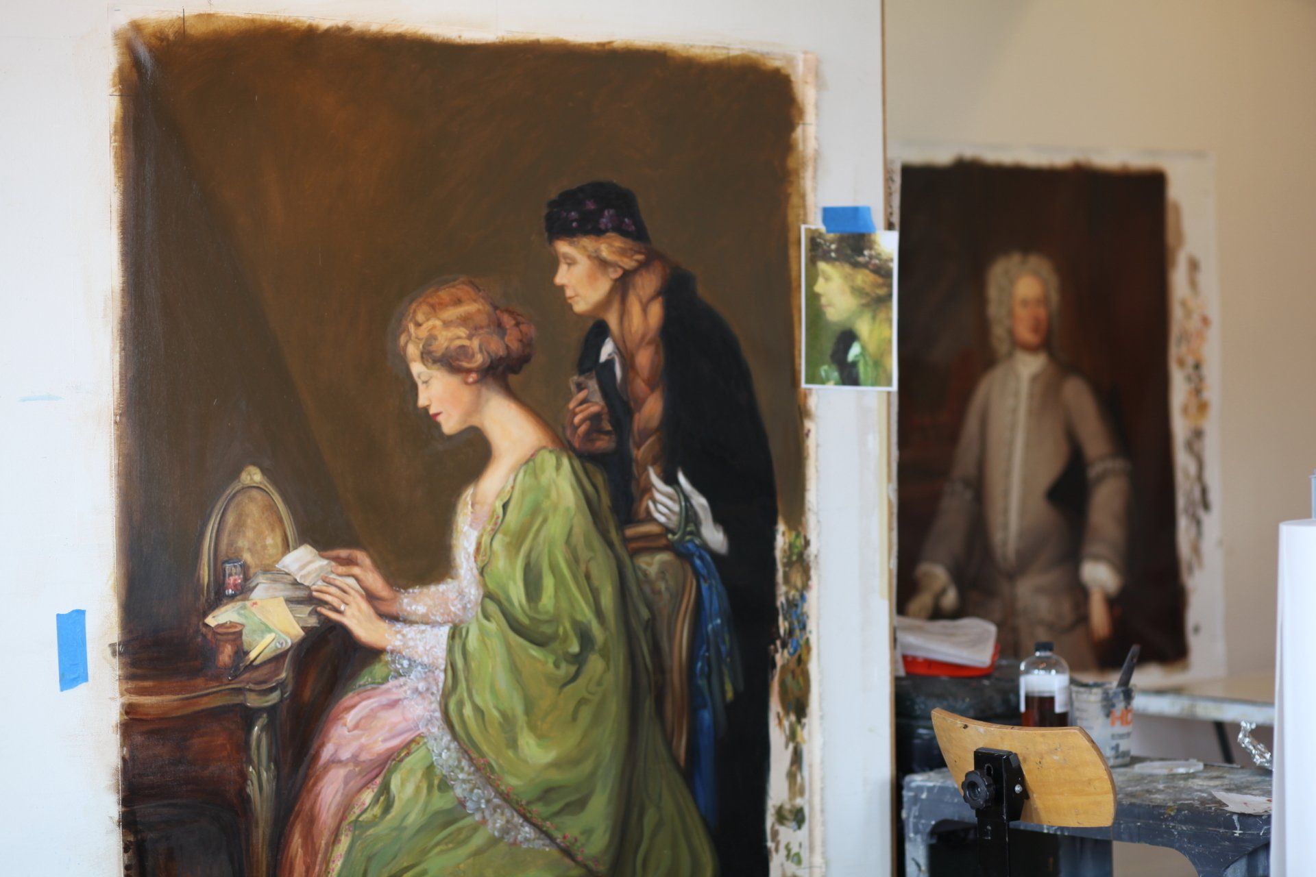 A painting of a man and a woman is being painted on a wall