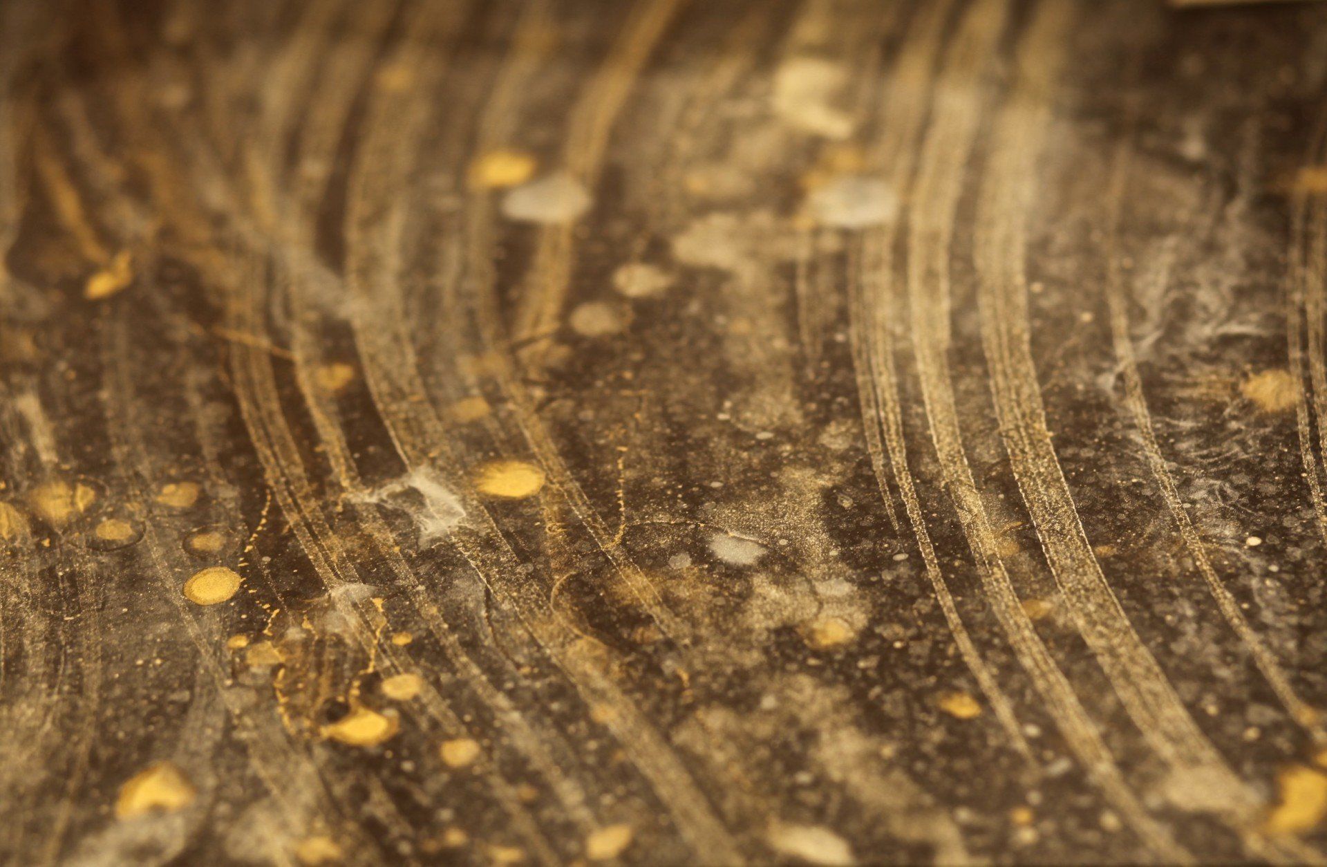 A close up of a dirty surface with a lot of dust on it.