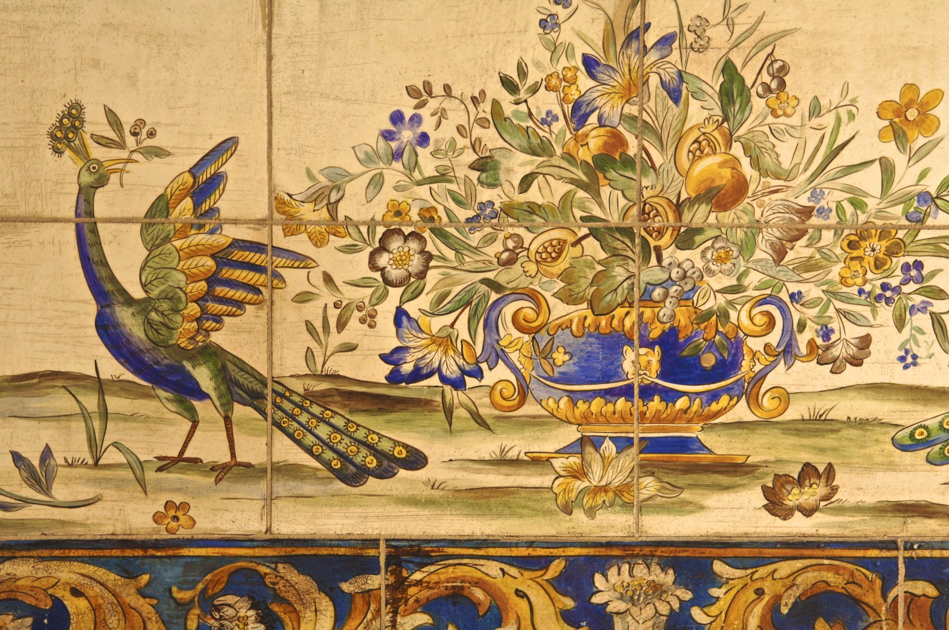 A painting of a peacock standing next to a vase of flowers