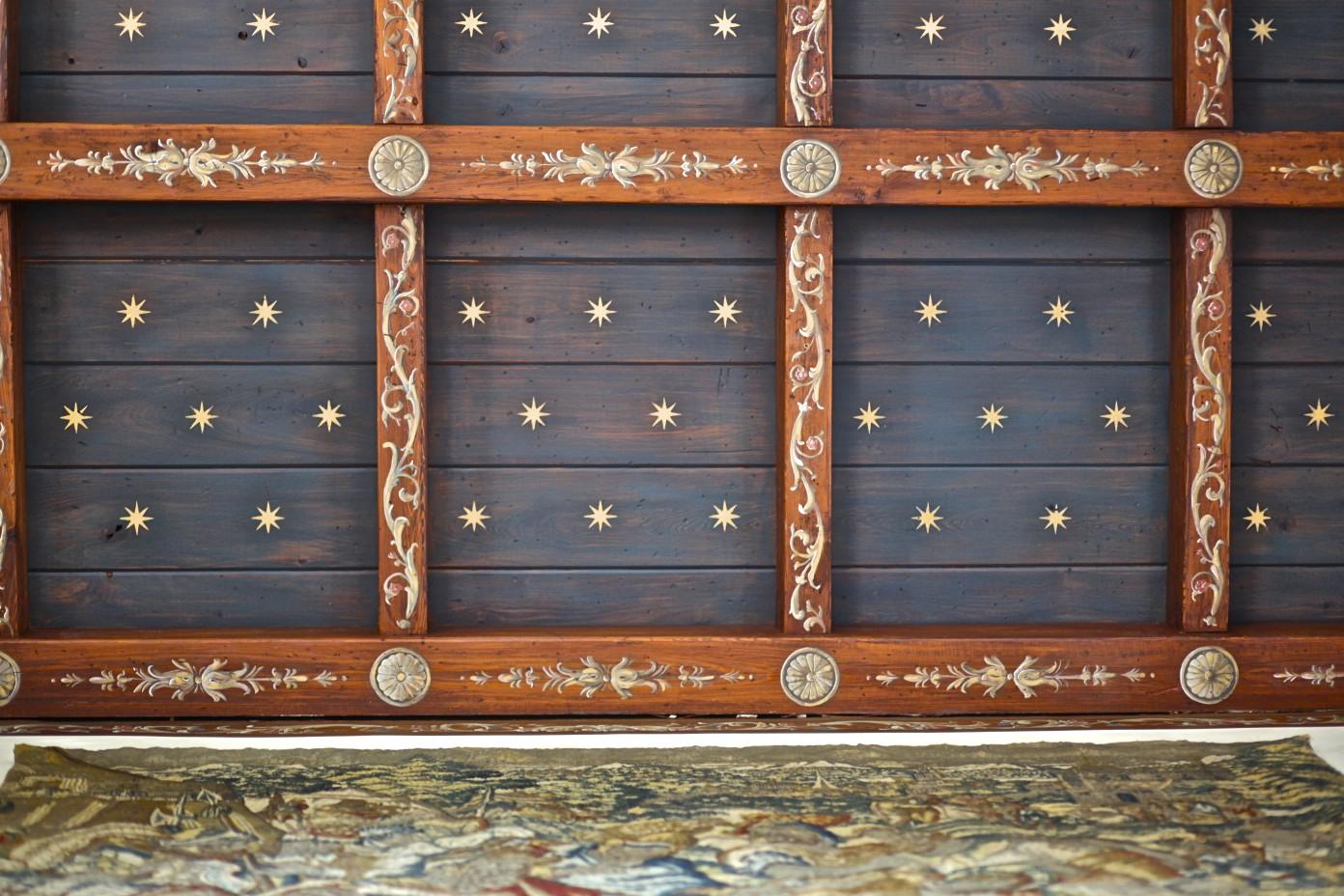 A wooden ceiling with a lot of stars on it