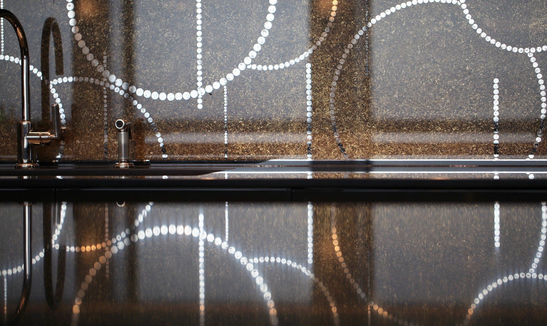 A kitchen counter with a sink and a faucet