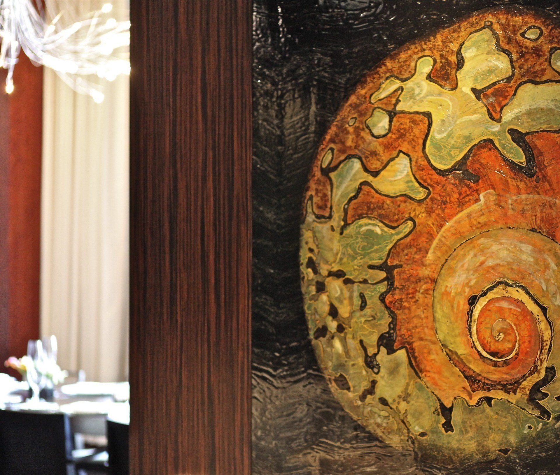 A painting of a sea shell is hanging on a wall