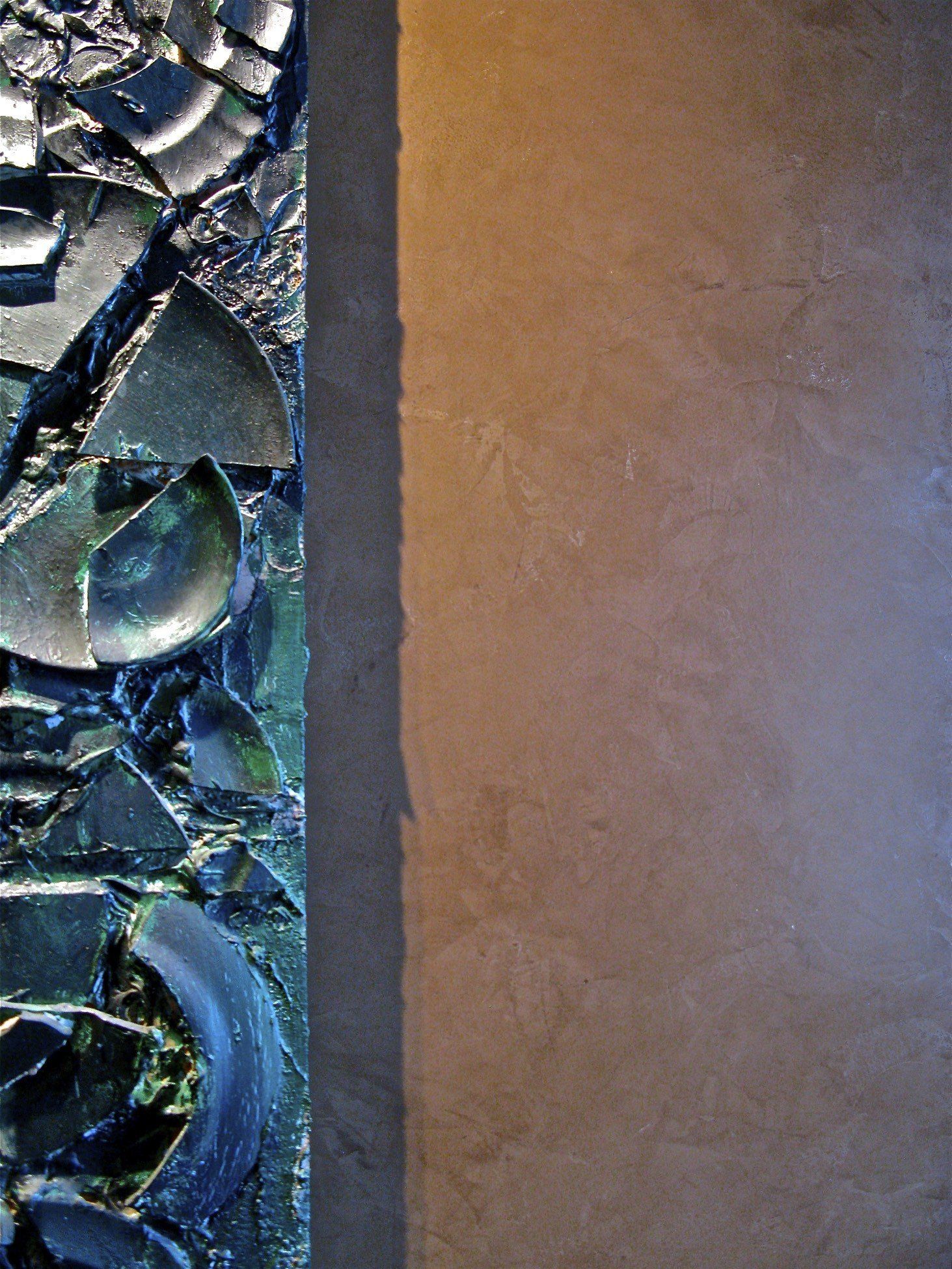 A close up of a wall with broken glass on it