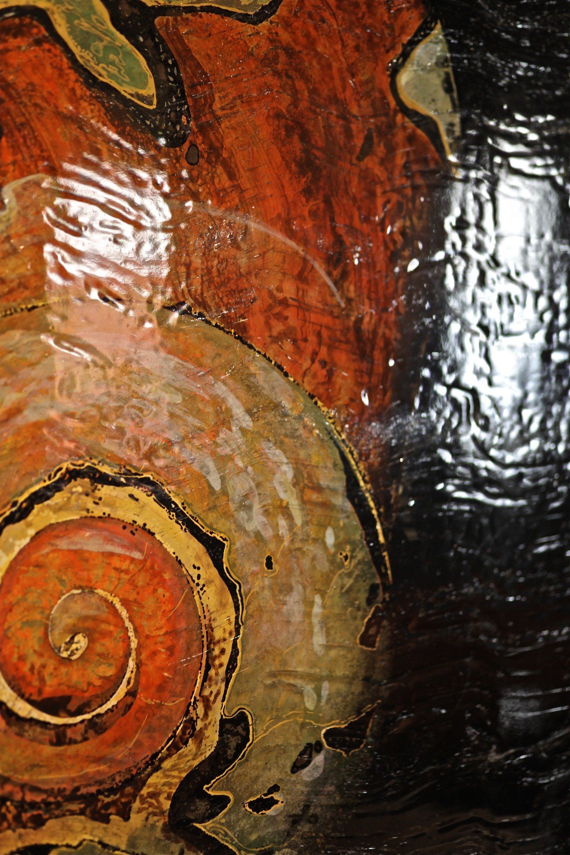 A close up of a painting of a swirl on a wall