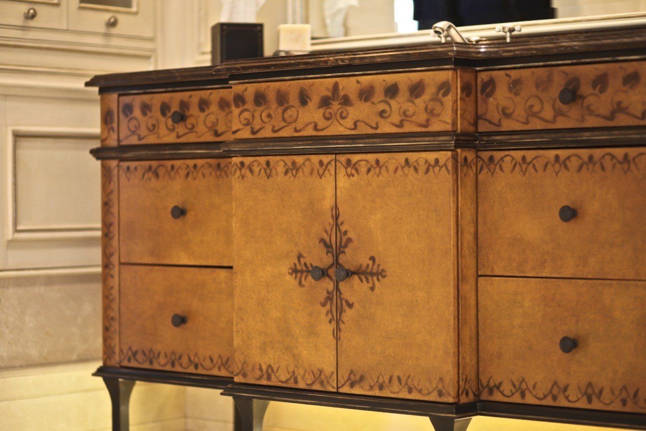 A wooden dresser with drawers and a mirror in a bathroom
