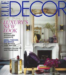 A living room with a fireplace and a mirror on the cover of a magazine.