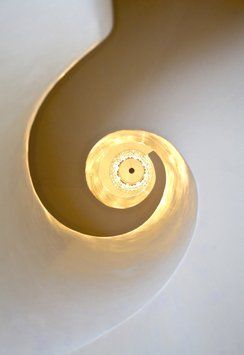 A spiral staircase with a light at the top of it.