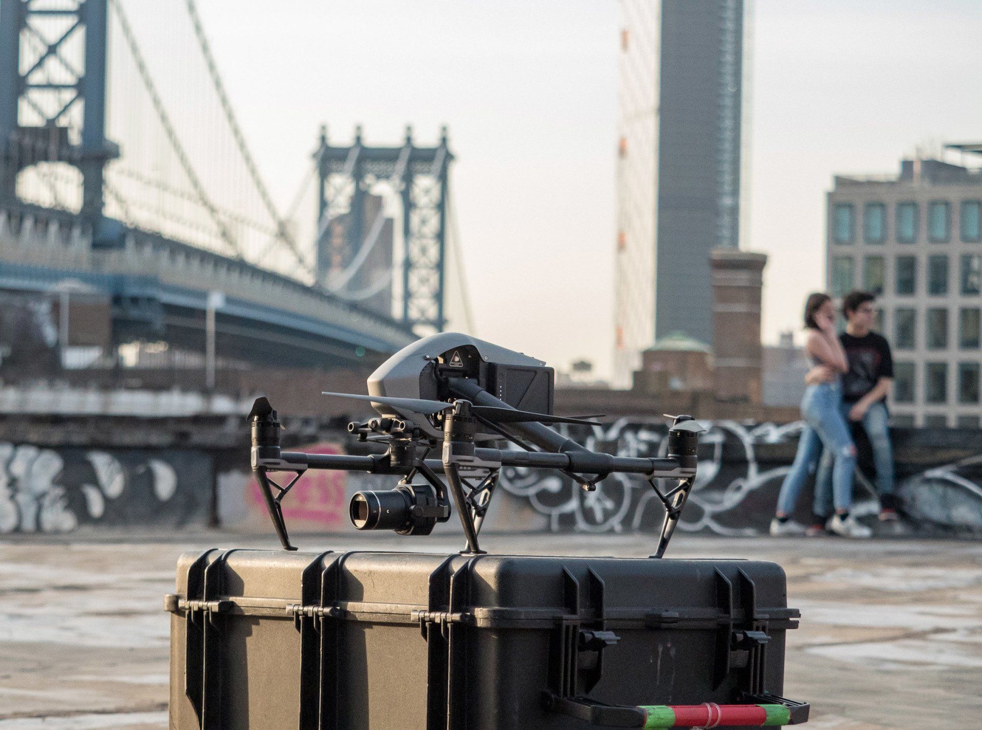 a drone is sitting on top of a case on a rooftop .