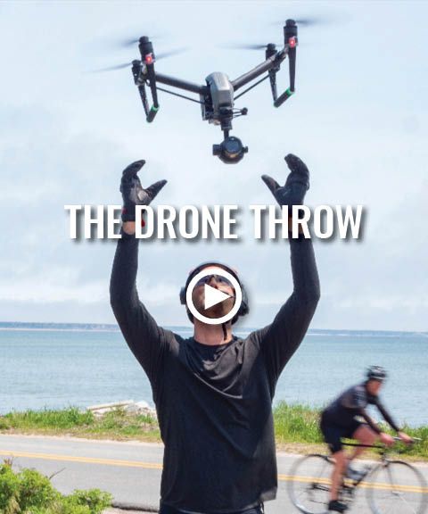 A man is throwing a drone in the air with the words the drone throw above him