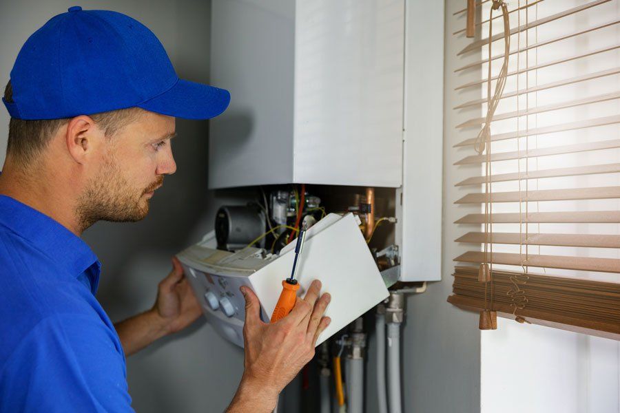 Maintenance and Repair Service Engineer Working with House Gas Heating boiler— Allentown, PA — Fred J Moyer Plumbing Inc Maintenance and Repair Service Engineer Working with House Gas Heating boiler— Allentown, PA — Fred J Moyer Plumbing Inc