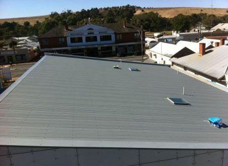 dark gray metallic roofing with small windows