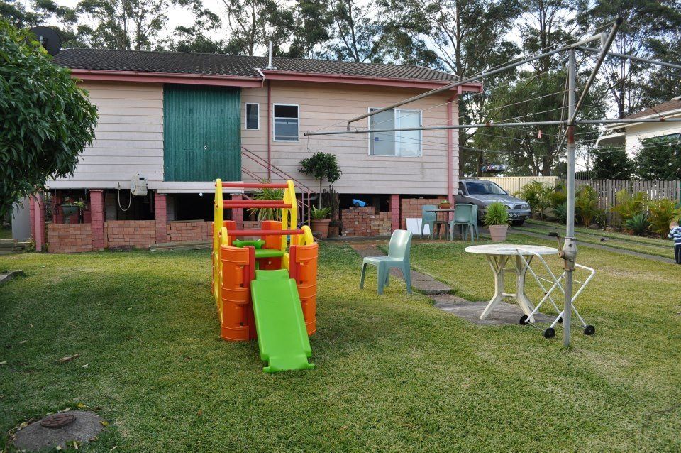 A house with a playground in front of it