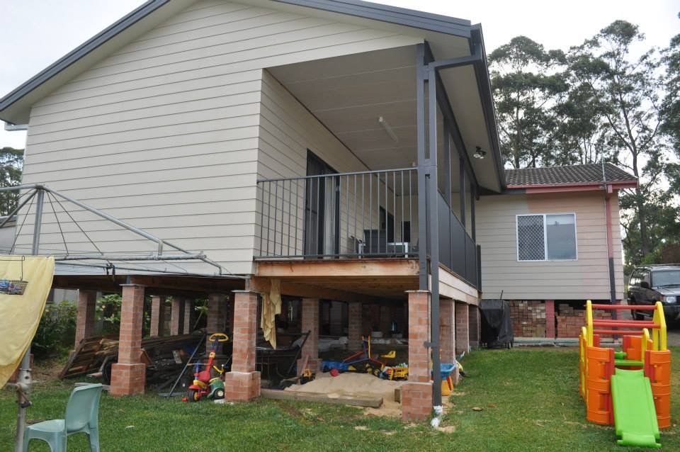 A house with a porch and a slide in front of it