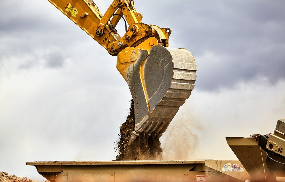 Construction Industry Heavy Equipment Excavator Moving gravel — Greg Thompson Earthmoving in Pink Lily, QLD