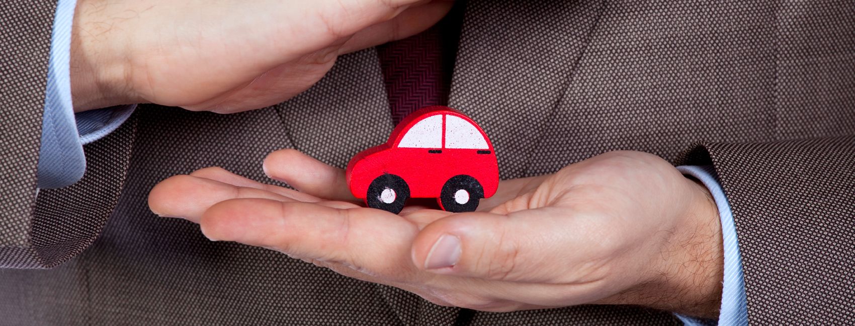 Man protecting toy car