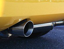 Muffler on Yellow Car - Auto Maintenance Muffler on Yellow Car - Auto Maintenance