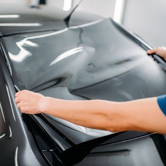 Window Tinting — Man Putting A Tint On A Car in Glen Burnie, MD Window Tinting — Man Putting A Tint On A Car in Glen Burnie, MD