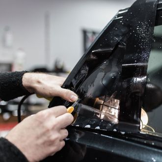 Automotive Tinting — Cutting A Tint Film in Glen Burnie, MD Automotive Tinting — Cutting A Tint Film in Glen Burnie, MD