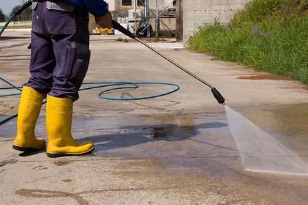 Man Cleaning The Apartment Exterior — Chula Vista — JetCleanUSA Inc. Man Cleaning The Apartment Exterior — Chula Vista — JetCleanUSA Inc.