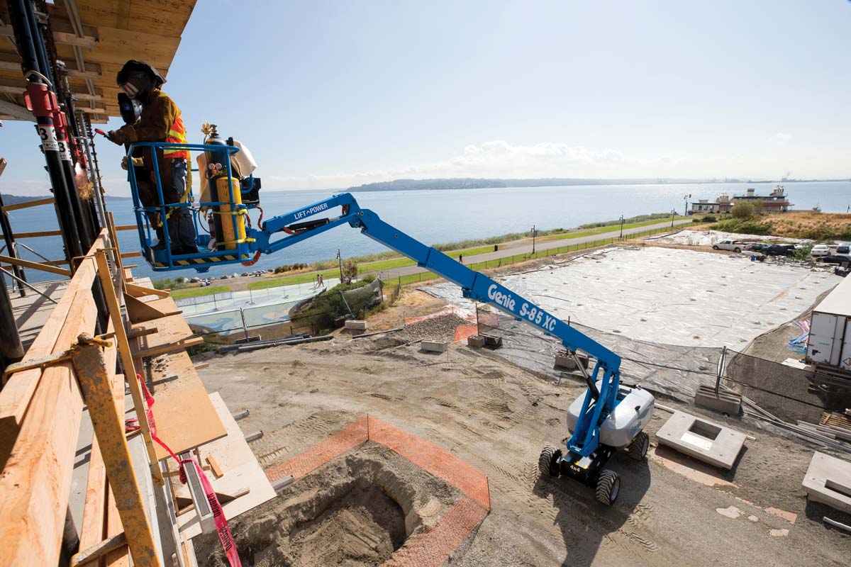 A group of construction workers are working on a building.