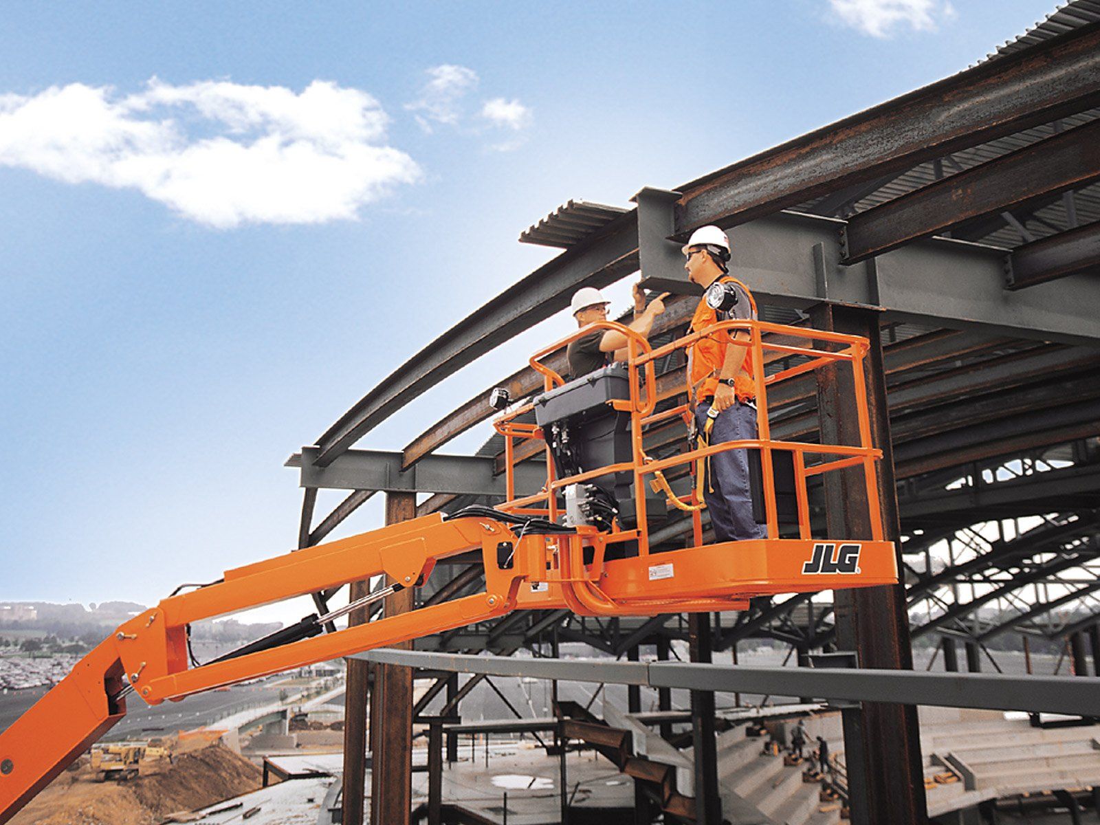 A group of construction workers are working on a jlg lift