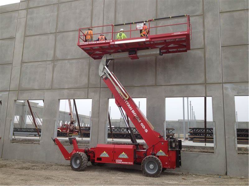 A red aerial lift is being used to work on a building
