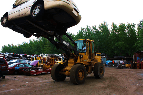 Front Loader Carrying A Car — Kearny, NJ — Bibbs Auto Recycling