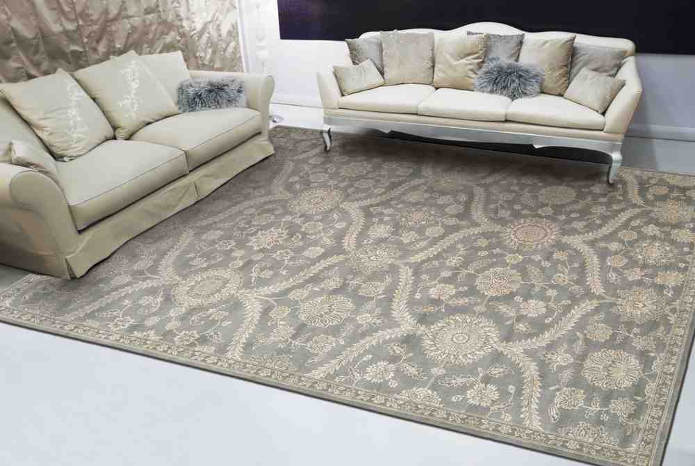 Living room with two beige sofas and a large patterned area rug